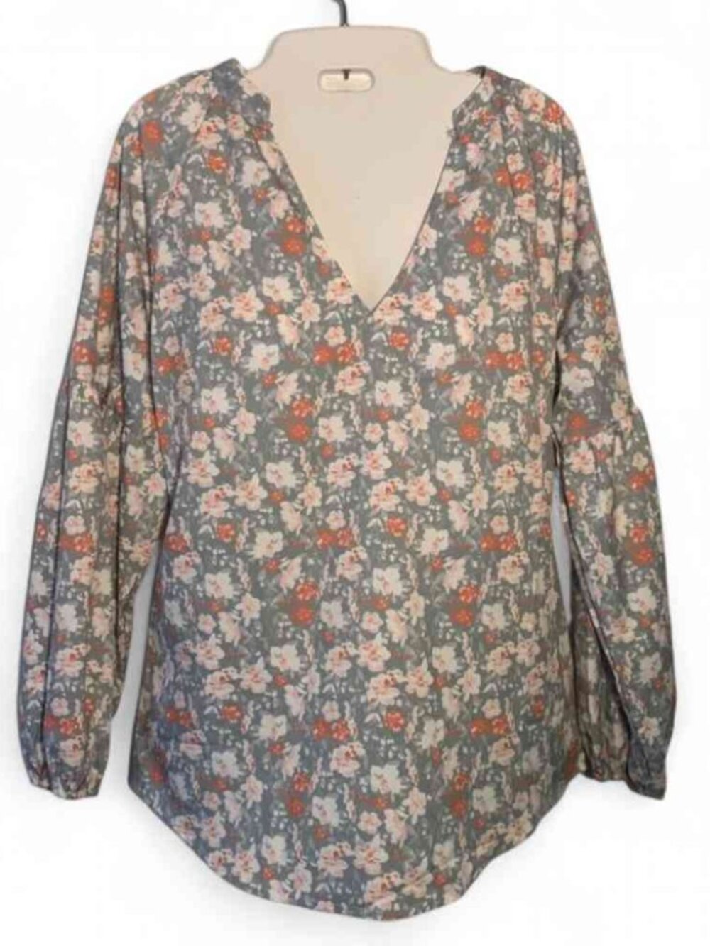 Floral print blouse with a V neck and long sleeves, featuring a grey and orange